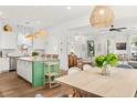 Open-concept kitchen with island seating that flows seamlessly into the adjacent dining and living areas at 383 Oak Park St, Summerville, SC 29486