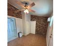 Bedroom featuring exposed brick accent walls and a ceiling fan at 4324 Purdue Dr, North Charleston, SC 29418