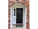 A closer view of the arched doorway showcasing a dark front door with sidelight at 4324 Purdue Dr, North Charleston, SC 29418