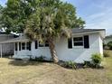 Side view of a single-story home with black shutters and a well-maintained lawn at 4626 W W Montague Ave, North Charleston, SC 29418