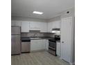 Bright kitchen with stainless steel appliances, white cabinets and plenty of counter space at 4652 Nibbs Ln, North Charleston, SC 29418