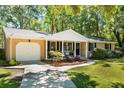 Charming single-story brick home featuring a covered porch and a well-maintained front yard with mature trees at 520 Yale Dr, Charleston, SC 29412