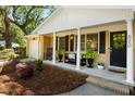 Inviting front porch with rocking chair and bench, enhanced by landscaped plants for a welcoming curb appeal at 520 Yale Dr, Charleston, SC 29412