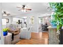 Bright living room featuring hardwood floors, ceiling fan, and an open concept connecting to the kitchen and dining area at 520 Yale Dr, Charleston, SC 29412