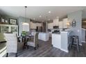 Spacious kitchen with a breakfast bar, granite countertops, stainless steel appliances, and modern fixtures at 543 Verdi Dr, Summerville, SC 29486