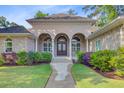 Charming brick home with arched entryway, lush landscaping, and a welcoming walkway at 5433 Clearview Dr, North Charleston, SC 29420