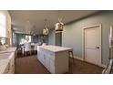 This kitchen features an island with a marble countertop and views to the open floor plan at 560 Hayes Park Blvd # Hr 12, Johns Island, SC 29455