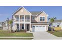 Charming two-story home with a welcoming front porch, two car garage and mature landscaping at 661 Black Pine Rd, Moncks Corner, SC 29461