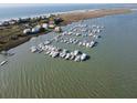 Aerial view of a boat harbor with waterfront homes and scenic shoreline on a sunny day at 67 W 10Th St # D-26, Folly Beach, SC 29439