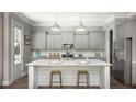 Modern kitchen with a large center island, stainless steel appliances, and sleek gray cabinetry at 784 Clay Field Trl, Summerville, SC 29485