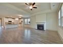 Open-concept living room showcasing hardwood floors, a cozy fireplace, and an adjoining modern kitchen at 8633 Connor Ct, North Charleston, SC 29406