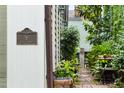 View of the street from the home's exterior with a detailed address sign, landscaping, and outdoor seating at 9 West St # 1, Charleston, SC 29401