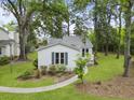 This single story home features light siding, manicured lawn, and a charming walkway to the front entrance at 987 Harbor Oaks Dr, Charleston, SC 29412