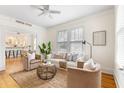 Cozy living room boasts an area rug and is adjacent to the kitchen and dining area at 103 Tall Oak Ave, Charleston, SC 29407