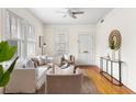 Bright living room featuring hardwood floors, neutral furniture, and a modern ceiling fan at 103 Tall Oak Ave, Charleston, SC 29407