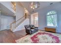 Expansive living room showcasing vaulted ceilings, hardwood floors, staircase and large windows at 106 Trimley Ct, Goose Creek, SC 29445