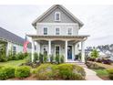 Charming two-story home with gray siding, inviting front porch, and manicured landscaping at 107 Clear Bend Ln, Summerville, SC 29486