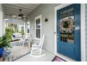 Inviting front porch with rocking chairs, ceiling fan, and charming decor at 107 Clear Bend Ln, Summerville, SC 29486