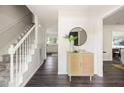 Bright foyer with wood floors, white staircase, and stylish cabinet with decor at 108 Old Dominion Dr, North Charleston, SC 29418