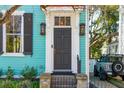 Home's elegant entryway featuring a black door, decorative sidelights, and stylish hardware at 11 Franklin St, Charleston, SC 29401