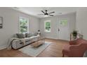 Bright living room featuring fresh paint, hardwood floors, a modern ceiling fan, and new furniture at 1109 Hillside Dr, Charleston, SC 29407