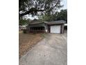Brick home featuring an attached garage and a covered parking area at 1130 Yeamans Hall Rd, Hanahan, SC 29410