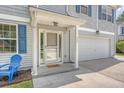 Inviting front entrance of home with gray siding, featuring blue chairs, storm door, and number 122 at 122 Balsam Cir, Summerville, SC 29485