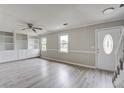 Bright living room with new flooring, built-in shelving, and a ceiling fan at 123 Wheeler Rd, Summerville, SC 29486