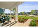 Inviting front porch with comfortable seating and views of the neighborhood at 1411 Homecoming Blvd, Ravenel, SC 29470