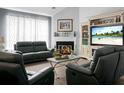 Comfortable living room with a fireplace, modern furniture, and a beach-themed entertainment center at 1485 Endicot Way, Mount Pleasant, SC 29466
