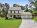 Beautiful two-story home with front porch, a two-car attached garage, and a well-maintained lawn at 1502 Southwick Dr, Johns Island, SC 29455