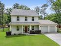 Charming two-story home with covered front porch, lush lawn, and a two-car attached garage at 1502 Southwick Dr, Johns Island, SC 29455