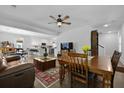 Spacious living room with hardwood floors, a ceiling fan, and an open floor plan, seamlessly connecting to the kitchen at 1502 Southwick Dr, Johns Island, SC 29455