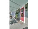 Inviting front porch featuring a red door, stylish decor, and comfortable seating at 1505 Fort Palmetto Cir, Mount Pleasant, SC 29466
