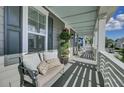 Inviting front porch featuring a seating bench with decorative pillows at 1505 Fort Palmetto Cir, Mount Pleasant, SC 29466