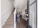 Inviting entryway with stairs and hardwood floors, leading into the open-concept living space at 153 Wild Holly Dr, Moncks Corner, SC 29461
