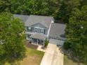 Aerial view of a well-maintained home with a lush green yard and mature trees at 186 Two Pond Loop, Ladson, SC 29456
