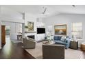 Bright living room boasts vaulted ceiling, fireplace, hardwood floors, and comfortable furniture at 2021 Arundel Pl, Mount Pleasant, SC 29464