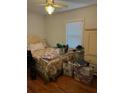 Bedroom with hardwood floors, a window, and a comfortable bed, awaiting personalized touches for a cozy retreat at 2066 Maybank Hwy, James Island, SC 29412