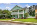 Charming two-story home featuring double porches, complemented by lush greenery and a well-kept lawn at 209 Forsythia Ave, Summerville, SC 29483
