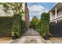 Wrought iron gate and vine-covered walls creating a private entrance at 21 1/2 Pitt St, Charleston, SC 29401