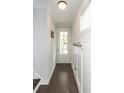 Bright foyer featuring dark wood floors, coat hooks, and a glass-paneled door at 2119 Oyster Reef Lane Ln, Mount Pleasant, SC 29466