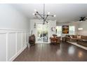 Spacious living room with dark wood floors, modern light fixture, and sliding glass doors to outdoor patio at 2119 Oyster Reef Lane Ln, Mount Pleasant, SC 29466