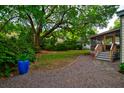 Screened-in porch overlooking backyard with large oak trees at 2169 Westrivers Rd, Charleston, SC 29412