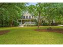 Charming two-story home with a welcoming front porch and beautifully manicured lawn at 225 River Oak Dr, Mount Pleasant, SC 29464