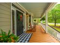 Cozy front porch featuring rocking chairs, a decorative wreath, and a charming welcome mat at 225 River Oak Dr, Mount Pleasant, SC 29464