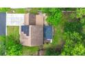Aerial view of the house with solar panels, a brick roof, mature trees and a large driveway at 2436 Stingray Blvd, North Charleston, SC 29406