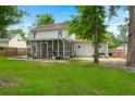 View of the back of the house, featuring a screened in porch and well maintained lawn at 2436 Stingray Blvd, North Charleston, SC 29406
