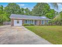 Attractive brick home with light blue shutters and front door, complemented by green landscaping and a driveway at 2534 Flamingo Dr, Charleston, SC 29414