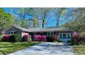 Beautiful brick home featuring vibrant azalea bushes along the front and a paved driveway at 2636 Elissa Dr, Charleston, SC 29414